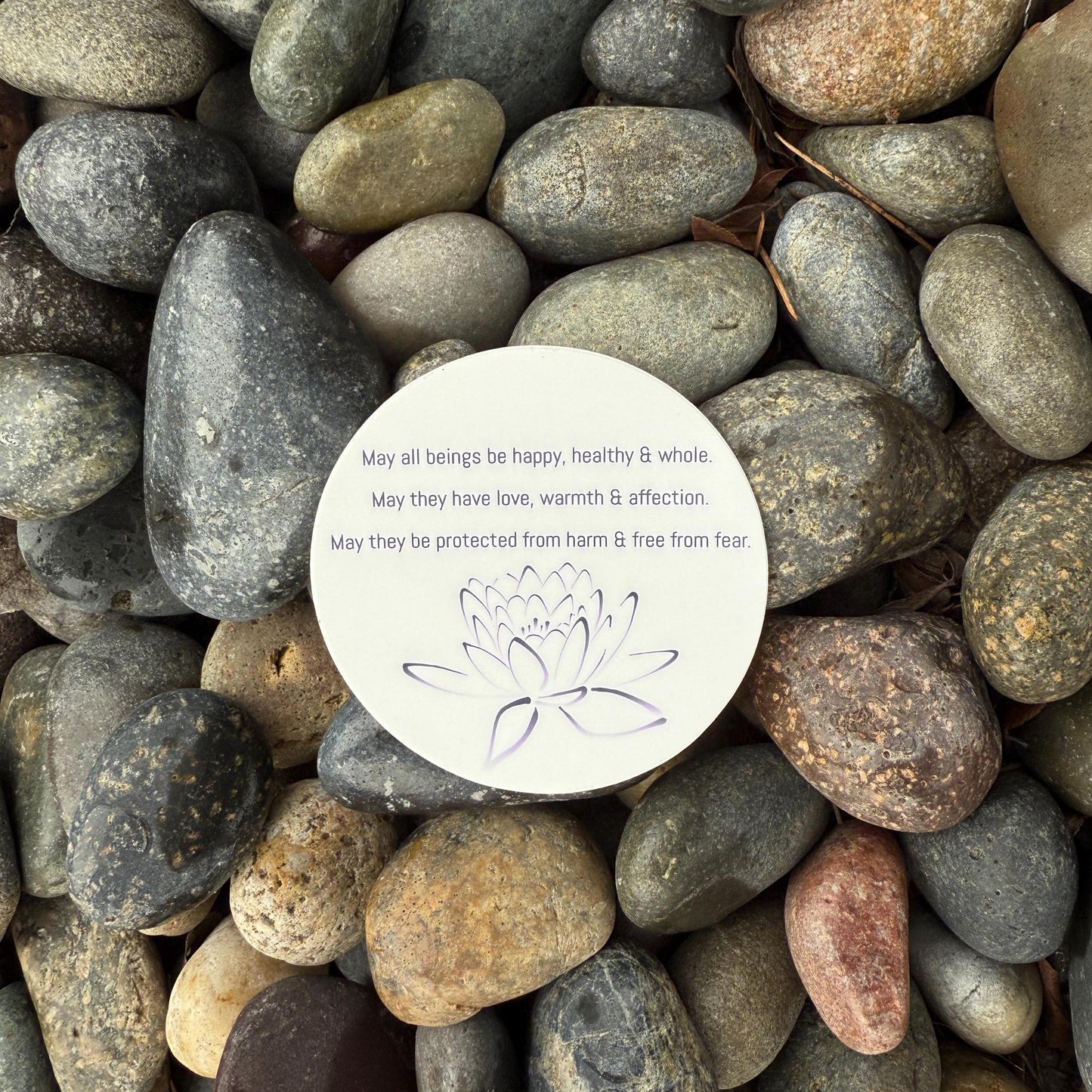 3" circular sticker with Buddhist prayer and a lotus design.