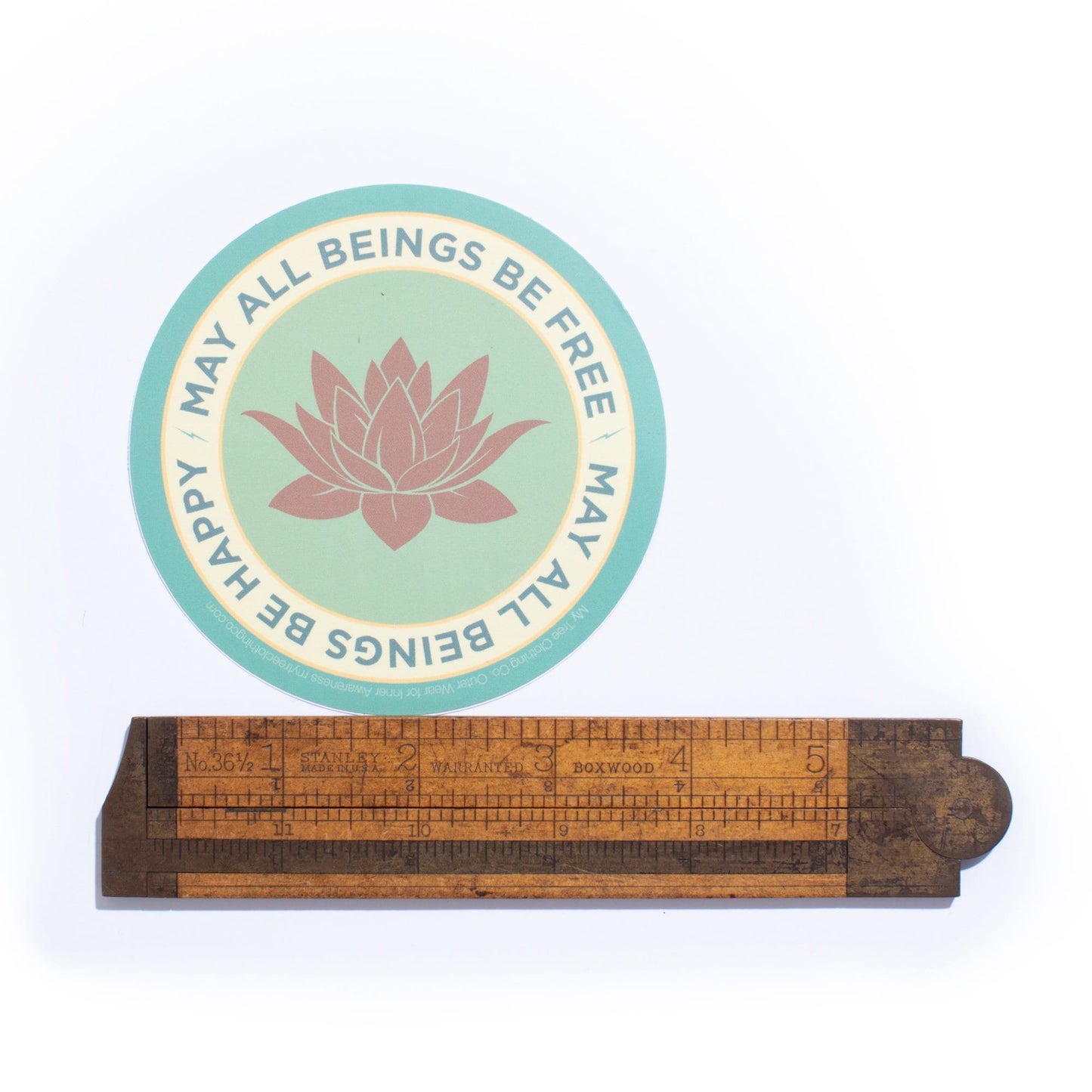 4" circle lotus flower design and text, MAY ALL BEINGS BE FREE MAY ALL BEINGS BE HAPPY.