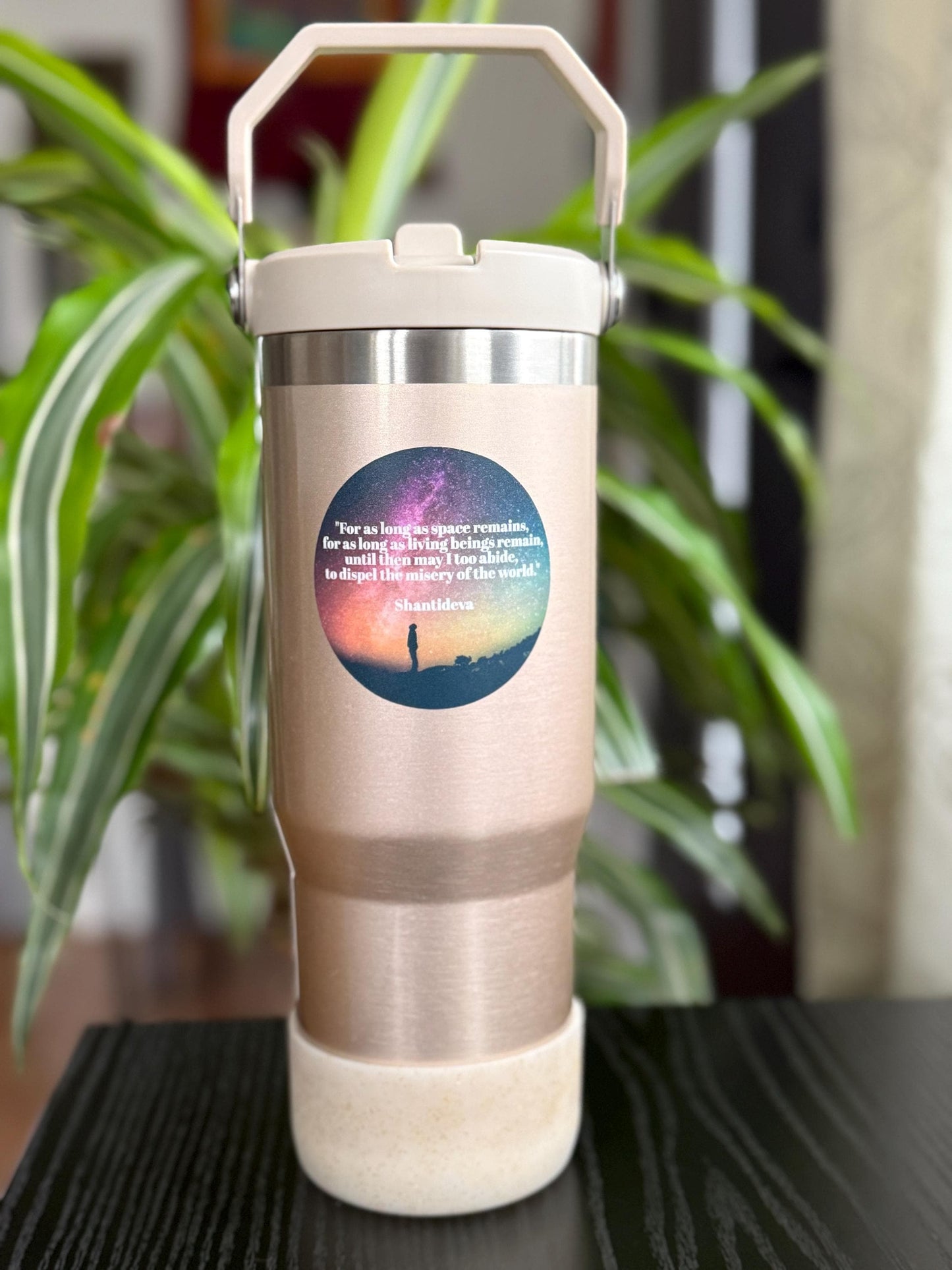 insulated tumbler with shantideva quote on a plant background