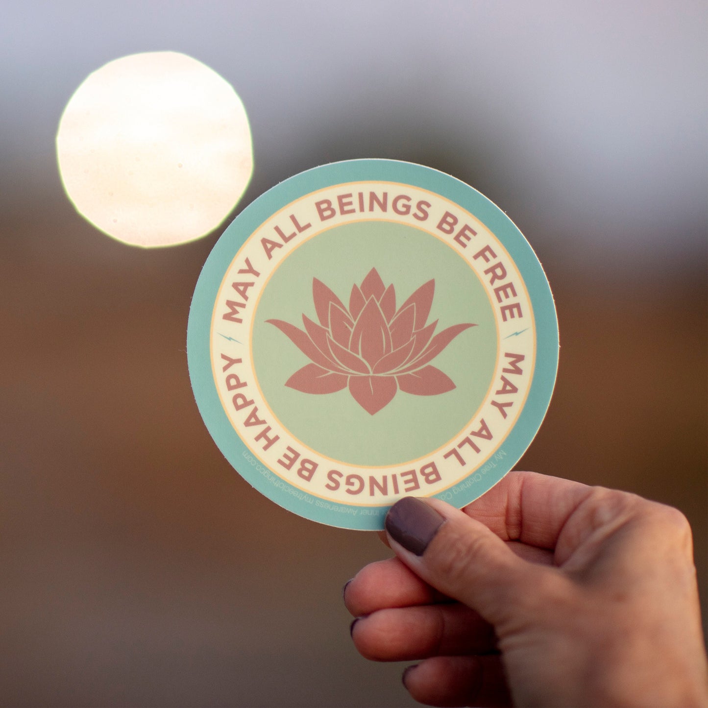 4" circle lotus flower design and text, MAY ALL BEINGS BE FREE MAY ALL BEINGS BE HAPPY.