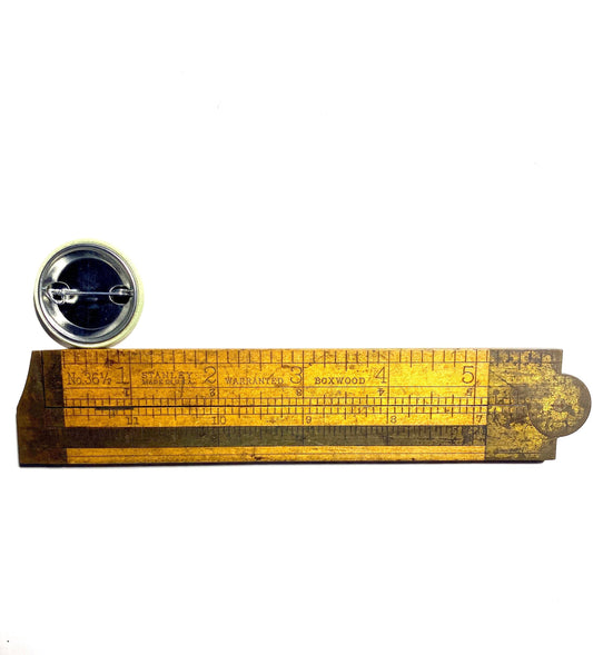 Vintage-style ruler measuring a 1.25" pin back button.