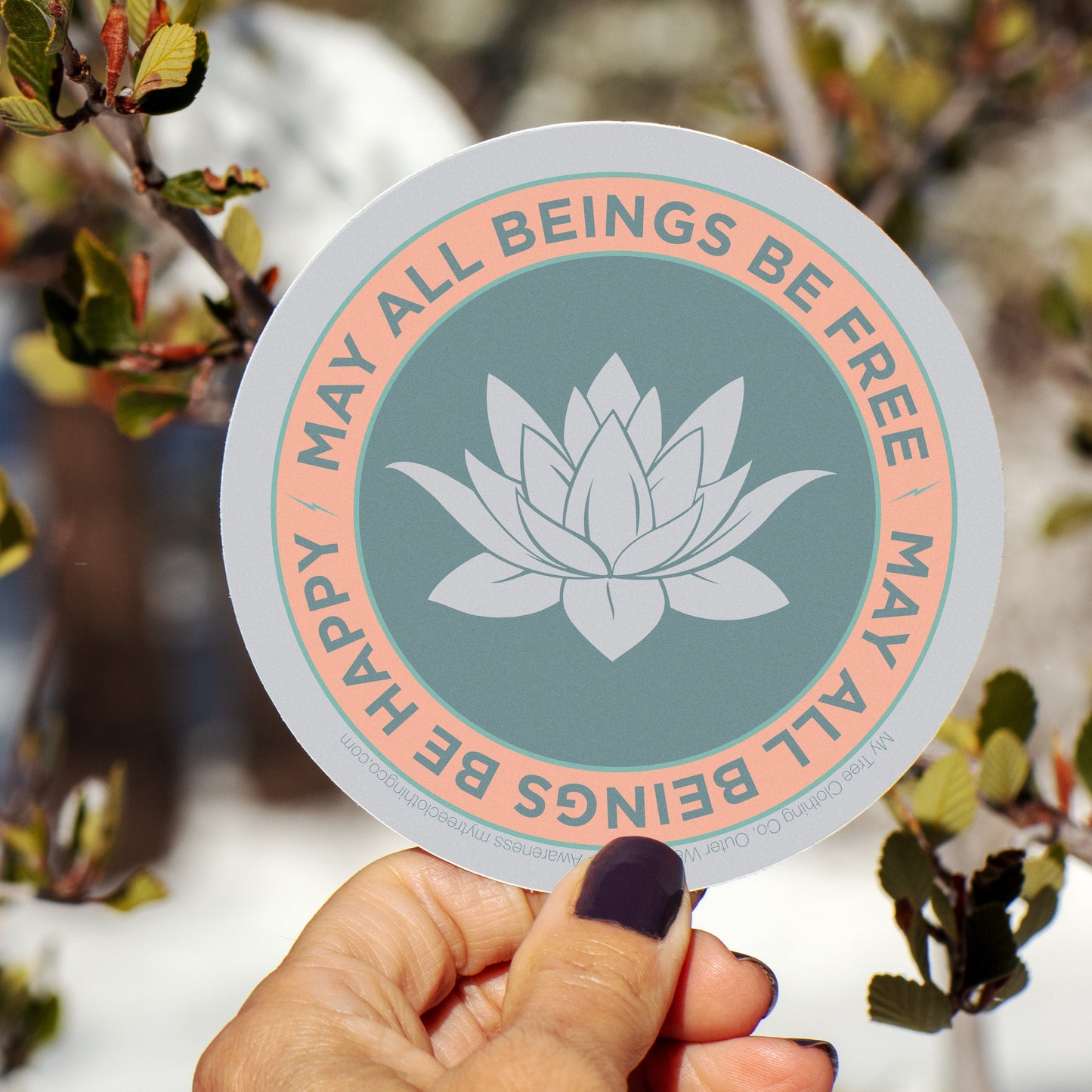 4" circular sticker with a lotus flower design and text, may all beings be free may all beings be happy.