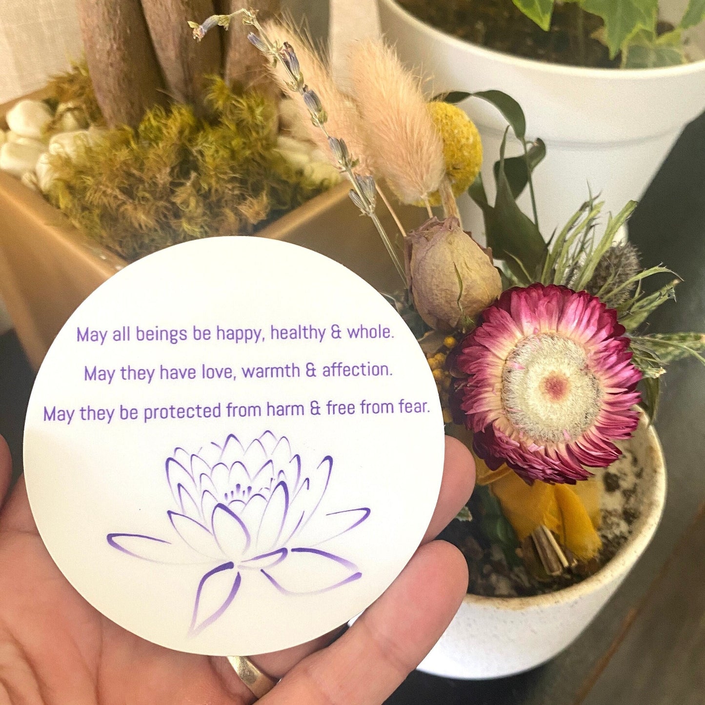 3" circular sticker with Buddhist prayer and a lotus design.