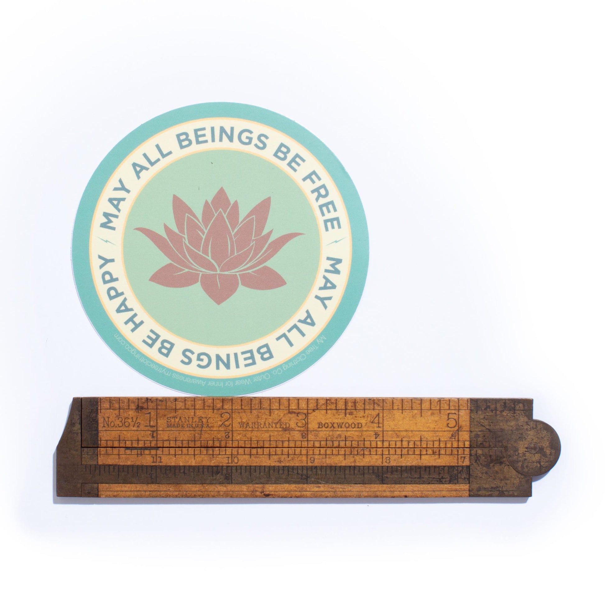 4" circle lotus flower design and text, MAY ALL BEINGS BE FREE MAY ALL BEINGS BE HAPPY.