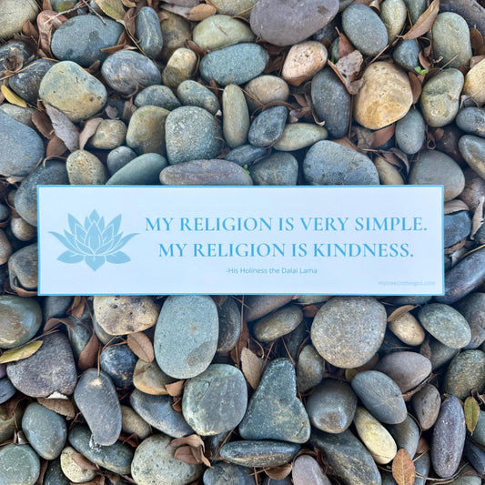 Bumper sticker with the quote by His Holiness the Dalai Lama, MY RELIGION IS SIMPLE. MY RELIGION IS KINDNESS, pebbles with a quote about kindness.
