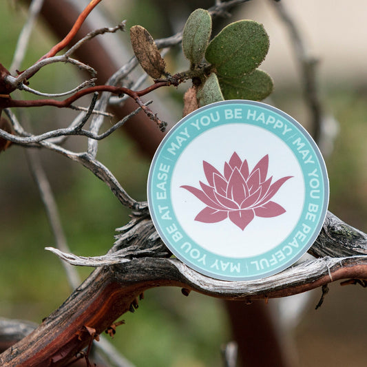 Round ultra thin magnet with pink lotus flower design and text, may you be happy may you be peaceful, may you be at ease, on a branch.