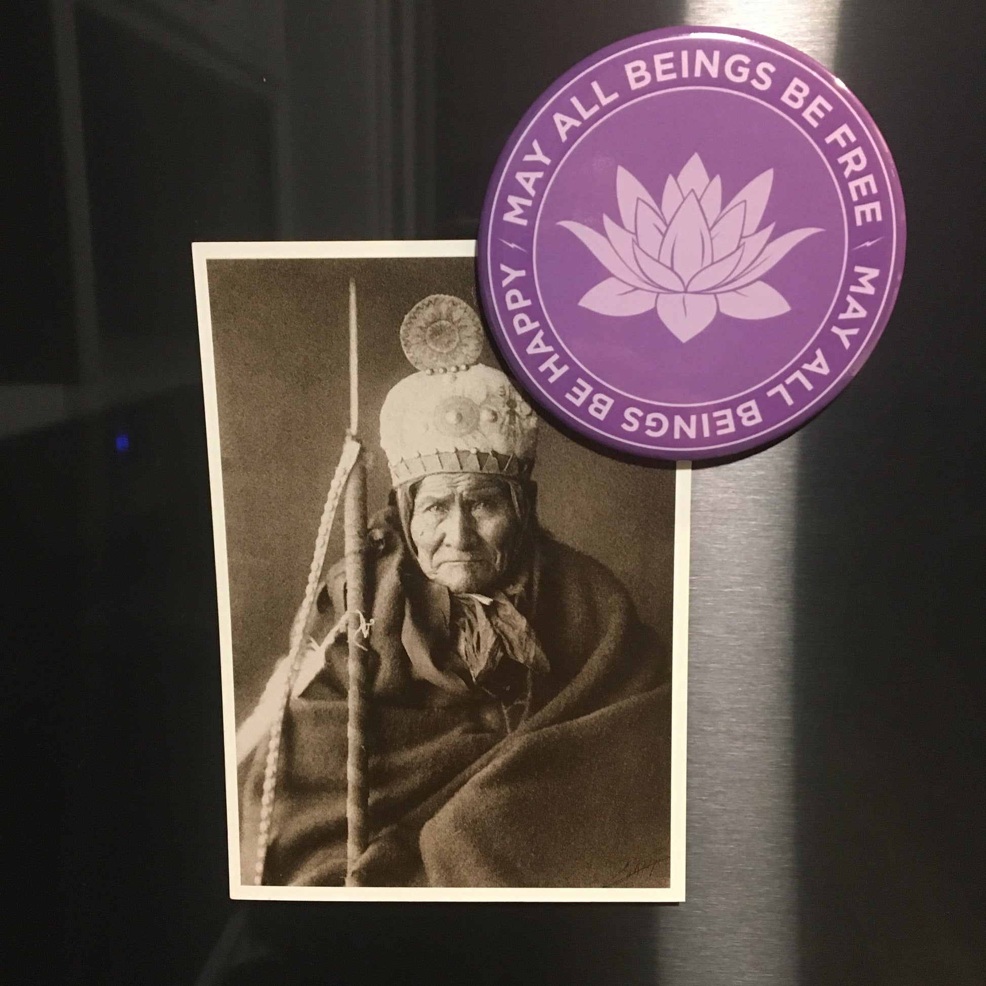Vintage photograph of Geronimo next to a purple magnet with lotus design and text, may all beings be free may all beings be happy.