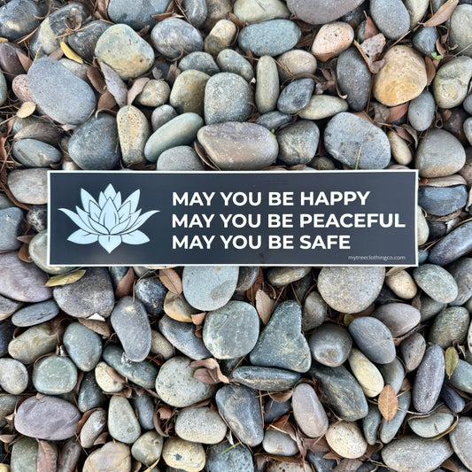Buddhist phrase, MAY YOU BE HAPPY-MAY YOU BE PEACEFUL-MAY YOU BE SAFE bumper sticker with a white lotus on pebbles.