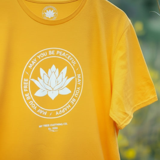 Yellow t-shirt with a white lotus flower graphic, may you be peaceful may you be happy may you be free.